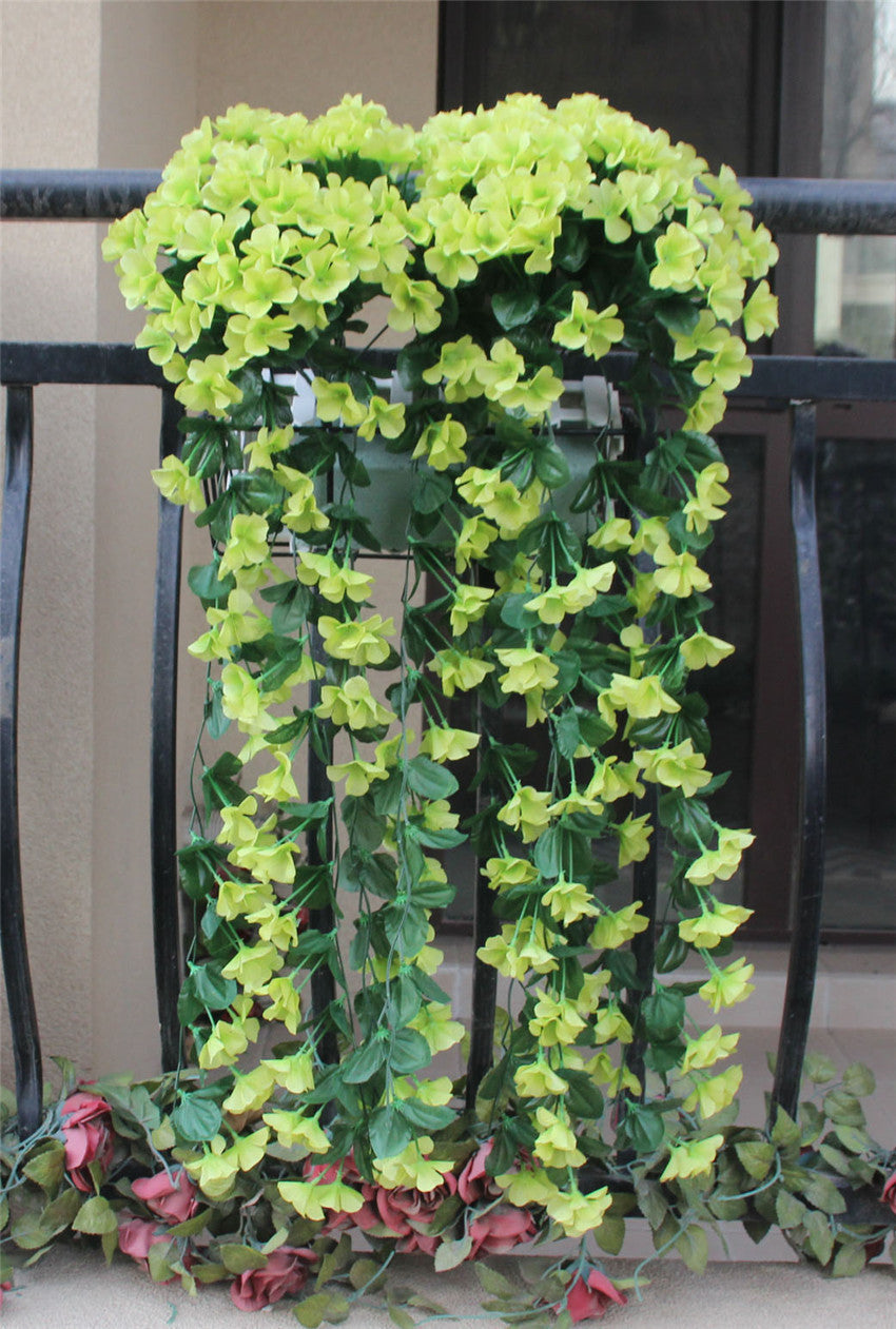 Violet Vines Hanging From Fake Flowers On The Window Balcony