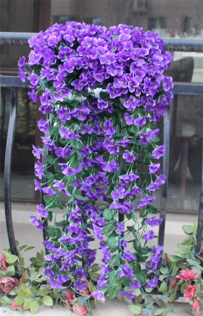 Violet Vines Hanging From Fake Flowers On The Window Balcony