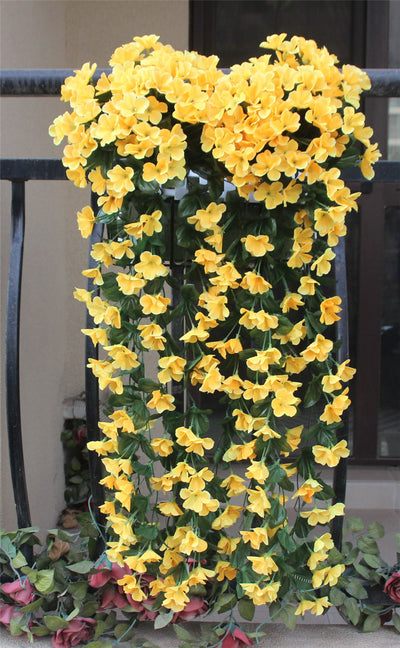 Violet Vines Hanging From Fake Flowers On The Window Balcony